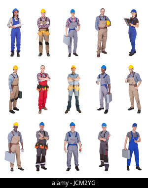 Full length of confident multiethnic engineers standing against white background Stock Photo