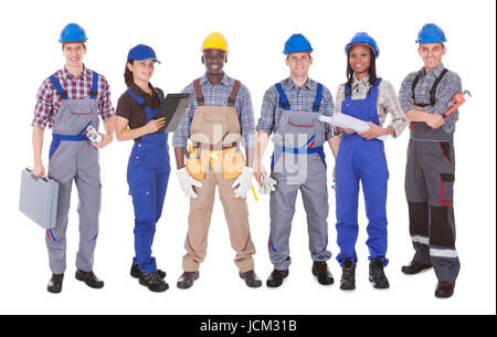 Full length portrait of multiethnic engineers standing against white background Stock Photo