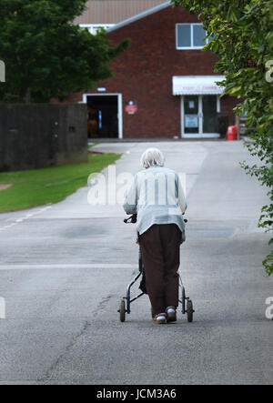 old woman with assist walking on pavement Stock Photo - Alamy