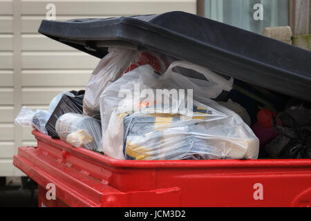 Over filled waste bin ready for collection. Stock Photo