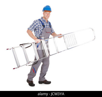 Confident worker carrying step ladder Stock Photo - Alamy
