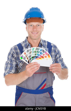 Handiman Color Portrait of a smiling workman showing the color swatch Stock Photo - Alamy