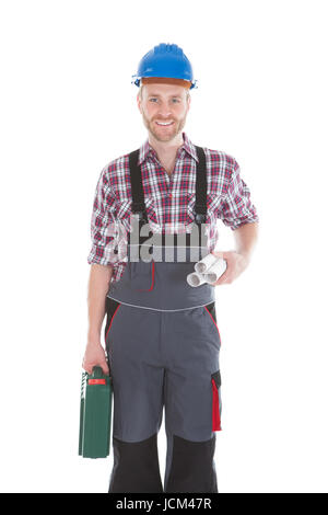 Full length portrait of confident architect holding rolled blueprints and tool kit over white background Stock Photo