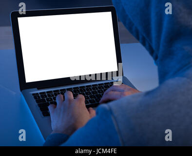 Cropped image of criminal using laptop to steal data at table Stock Photo