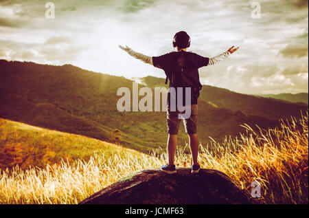 Hiker with backpack standing on top of a mountain with map Stock Photo ...