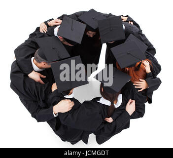 Graduate students standing in circle. Isolated on white Stock Photo
