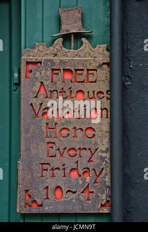 Decorative antique valuation sign outside an antique shop. Hastings. Sussex. England. UK Stock Photo