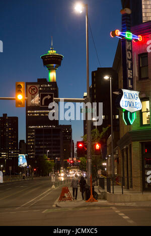 Night in Calgary, Canada. The Calgary Tower stands in the downtown district beyond the Hotel King Edward (the King Eddy Hotel) on 4th Street South Eas Stock Photo