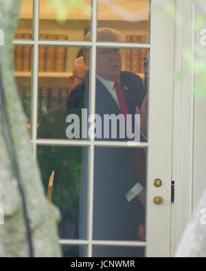 Washington, USA. 16th Jun, 2017. United States President Donald J. Trump prepares to open the door to depart the Oval Office of the White House in Washington, DC for a trip to Miami, Florida on Friday, June 16, 2017. In Miami, the President will give remarks and participate in a signing on the United States' policy towards Cuba. Credit: MediaPunch Inc/Alamy Live News Stock Photo