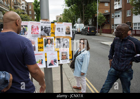 London, UK. 16th June, 2017. Local residents view missing person notices posted by family members and friends seeking help in tracing those still missing following the fire in the Grenfell Tower close to Latimer Road underground station. Credit: Mark Kerrison/Alamy Live News Stock Photo