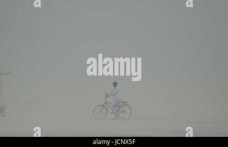 Allahabad, Uttar Pradesh, India. 16th June, 2017. An Indian cyclist walk through a dust storm at the Sangam, the confluence of the Ganges, Yamuna and mythical Saraswati rivers in Allahabad. Credit: Prabhat Kumar Verma/ZUMA Wire/Alamy Live News Stock Photo