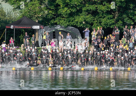 Rutland Water, UK. 17th June, 2017. Rutland Water, UK. 17th June, 2017. The second wave of competitors (men aged 45-80) start the 1500 meters swim phase of the Dambuster Triathlon (swim, bike and run race) at Rutland Water, England, on 17th June 2017. Credit: Michael Foley/Alamy Live News Stock Photo
