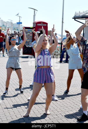 Brighton, UK. 17th June, 2017. A dance group goes through some moves on Brighton seafront in the glorious sunshine as hot weather sweeps across Britain this weekend with temperatures reaching the high 20s celsius Credit: Simon Dack/Alamy Live News Stock Photo