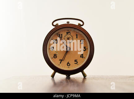 Close up view of antique clock with broken glass on white background Stock Photo