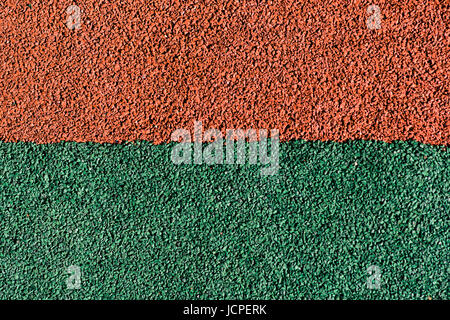 Rubber colored safety coating of sports playground closeup background Stock Photo