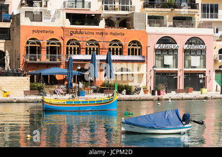 Boats in the harbour at St Julians Bay Malta on a sunny summer day with buildings in the background Stock Photo