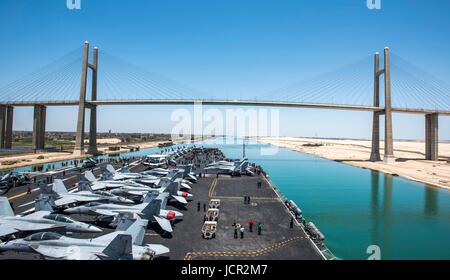The U.S. Navy Nimitz-class aircraft carrier USS George H.W. Bush sails under the Mubarak Peace Bridge as transits the Suez Canal June 5, 2017 in El Qantara, Egypt. Stock Photo