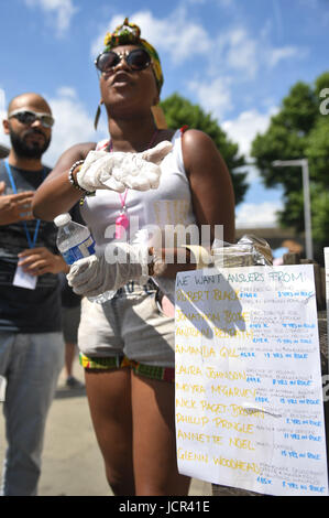 A protester near Grenfell Tower in west London demanding answers over the disaster after a fire engulfed the 24-storey building on Wednesday morning. Stock Photo