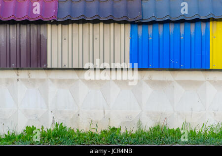 The Colorful galvanized sheet on concrete wall Stock Photo