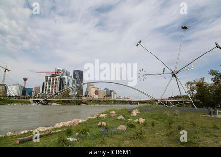 A pedestrian bridge links St Patrick's Island to Calgary, Canada. The area is popular with walkers and cyclists. Stock Photo
