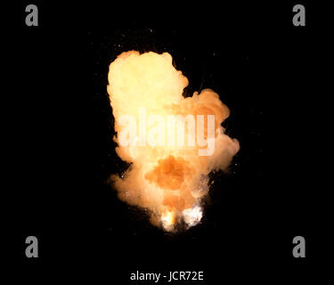 Huge, extremely hot explosion with sparks and hot smoke, against black background Stock Photo