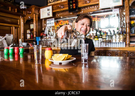 Bartender pouring a shot of mezcal, La Casa del Mezcal - Oaxaca, Mexico Stock Photo