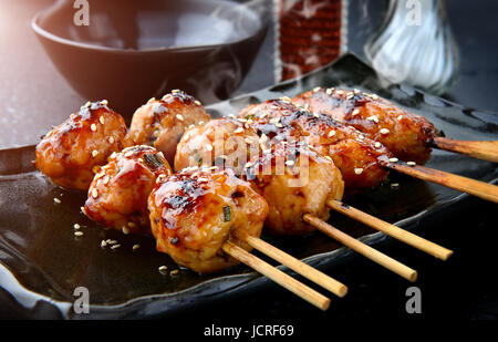 japanese meatball grill  or tsukune cooked with teriyaki sauce ready to eat photo in studio lighting. Stock Photo