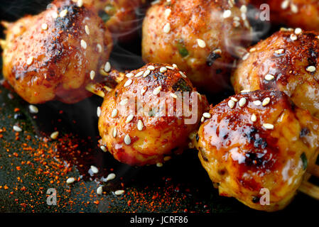 japanese meatball grill  or tsukune cooked with teriyaki sauce ready to eat photo in studio lighting. Stock Photo