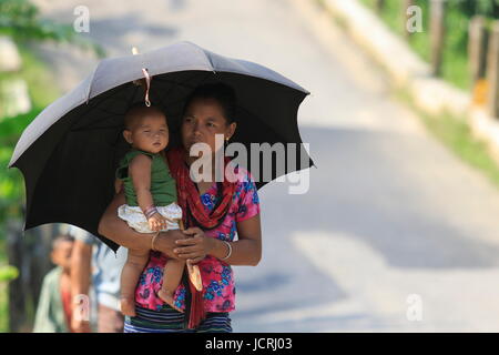 An ethnic woman holds a baby in Rnagamati, Chittagong, Bangladesh. Stock Photo