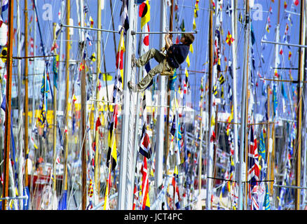 The International  Festival of the Sea involving 1000 boats,  was held Portsmouth Naval Dockyard in 2001. A boy in a bosun's chair climbs a mast. Stock Photo