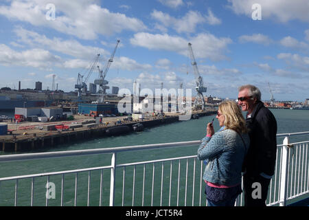 Smiling couple on board Brittany Ferries Cap Finistere ferry as it arrives in Portsmouth Docks Uk Stock Photo