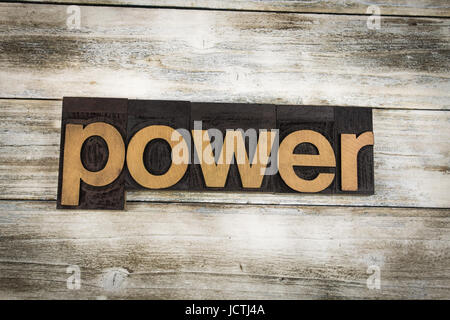 The word 'power' written in wooden letterpress type on a white washed old wooden boards background. Stock Photo