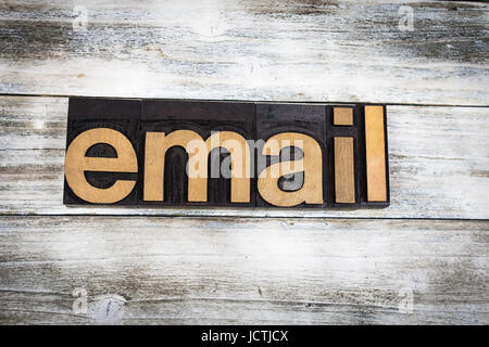 The word "email" written in wooden letterpress type on a white washed old wooden boards background. Stock Photo