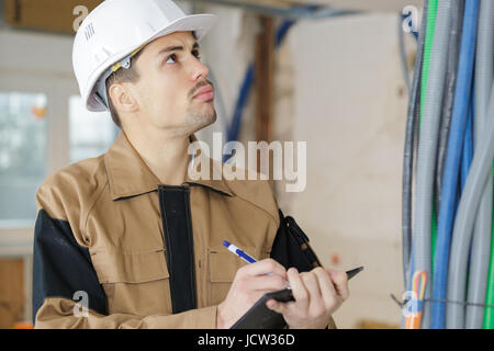 smart pensive builder thinking about something indoors Stock Photo
