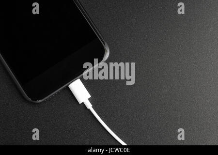 phone connecting usb port on black background top view Stock Photo