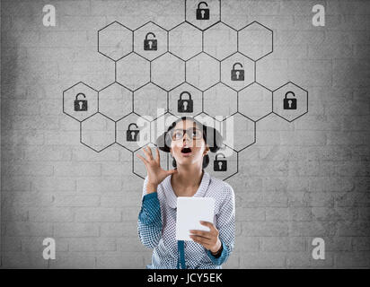Thoughtful businesswoman with hexagonal lock security concept Stock Photo