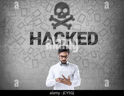 Businessman using digital tablet in front of hacked symbol Stock Photo
