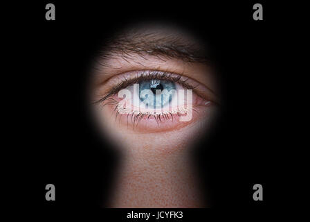 man peeping through keyhole privacy concept Stock Photo