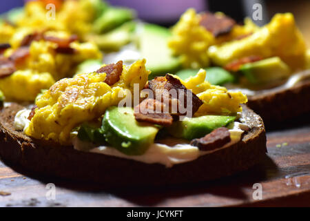 Colorful and delicious loaded avocado toast. Stock Photo