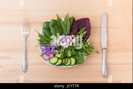 Salad with different leaves, vegetables and flowers Stock Photo