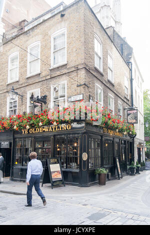 A man walks past Ye Olde Watling public house on the corner of Watling street and Bow Lane, London, England, United Kingdom Stock Photo