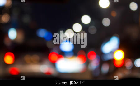 Defocus car tail lights in the night traffic. The shot was taken by altering the lens focus ring. Stock Photo