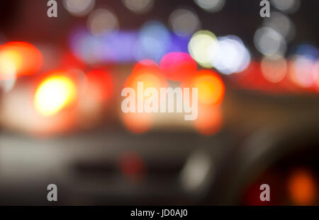 Defocus car tail lights in the night traffic. The shot was taken by altering the lens focus ring. Stock Photo