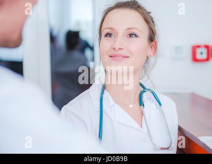 Female Medical Doctor in Conversation with Other Medical Staff. Hospital Work. Stock Photo