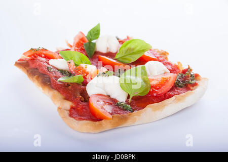 pizza pomodoro, vegetarian and homemade with mozzarella, tomatoes and basil isolated on white background Stock Photo