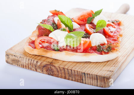 pizza pomodoro, vegetarian and homemade with mozzarella, tomatoes and basil isolated on white background Stock Photo