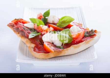 pizza pomodoro, vegetarian and homemade with mozzarella, tomatoes and basil isolated on white background Stock Photo