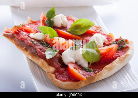 pizza pomodoro, vegetarian and homemade with mozzarella, tomatoes and basil isolated on white background Stock Photo