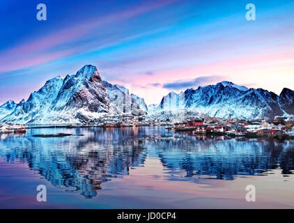 Mount Olstind reflected in the calm waters of Reinfjord on the Lofoten Islands Stock Photo