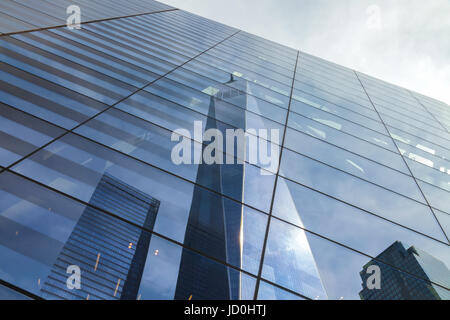 Reflection of the Freedom Tower on the adjacent building's window glasses in New York City, USA Stock Photo